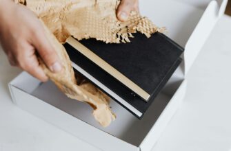 https://www.pexels.com/photo/anonymous-man-wrapping-pair-of-black-notebooks-in-packing-paper-4464823/